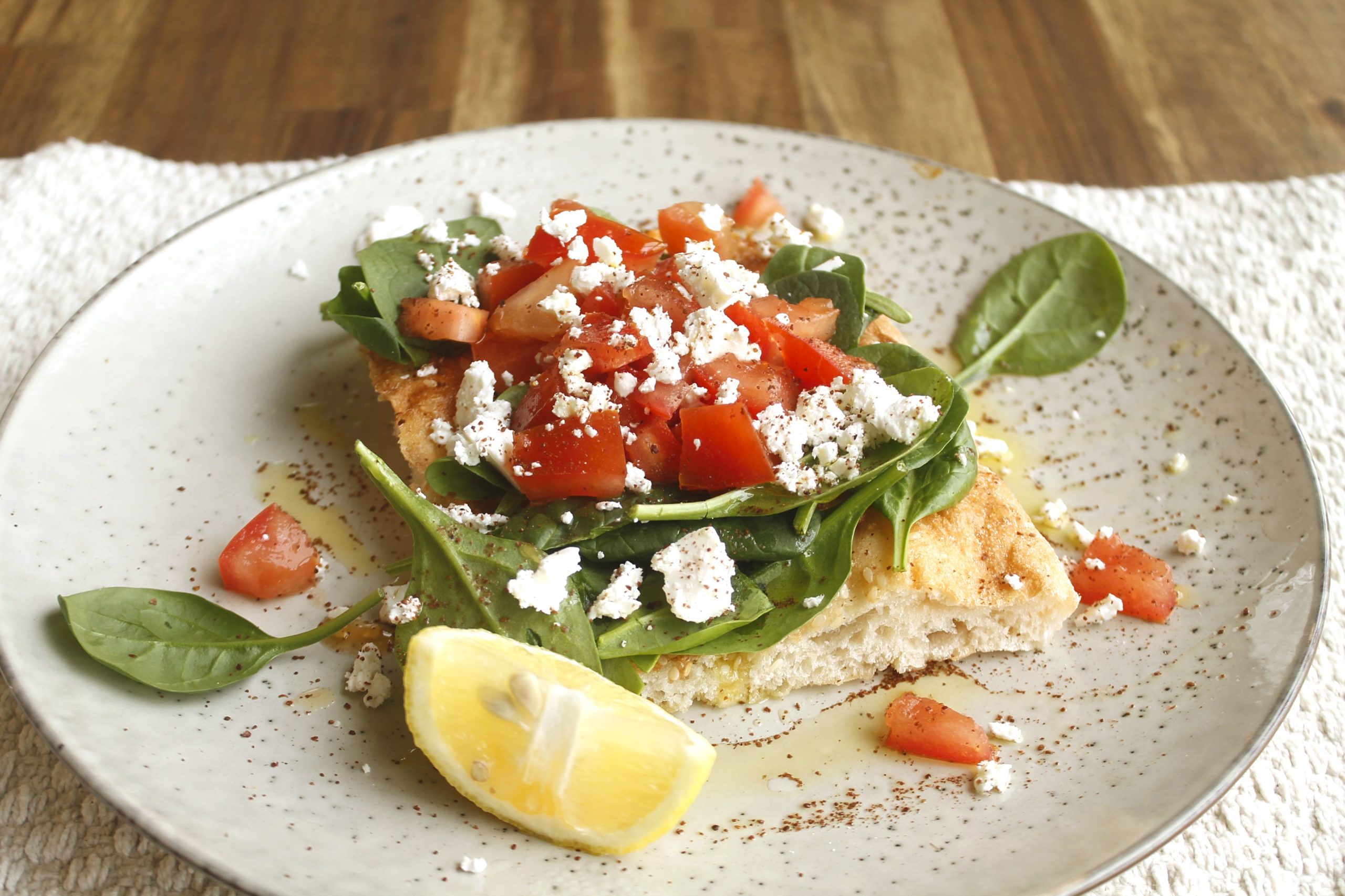 Turkish bread with baby spinach, tomatoes, feta, lemon and sumac